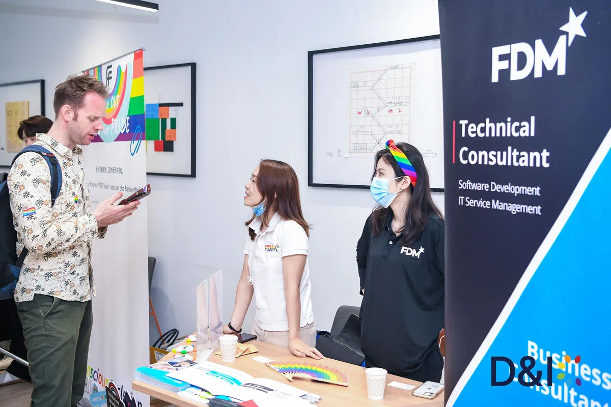 A visitor chats with FDM recruiters at their booth during the DNIC job fair