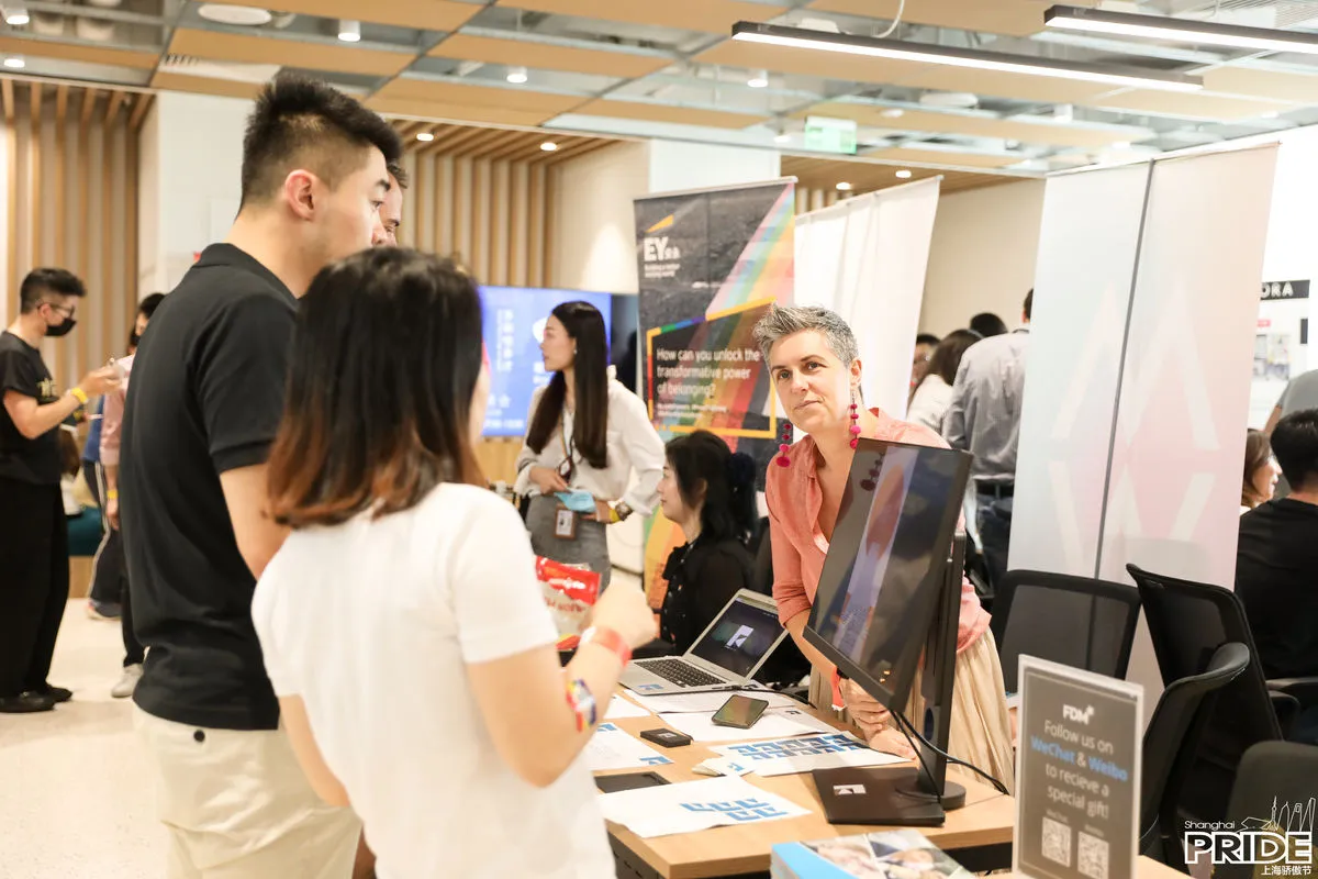 Job seekers talk with employers at the EY and FDM booths
